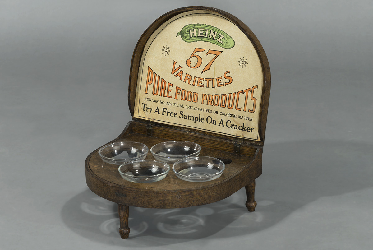 H.J. Heinz Company Sample Display Case, 1915-1930 Wooden display holding four glass bowls and a sign with text