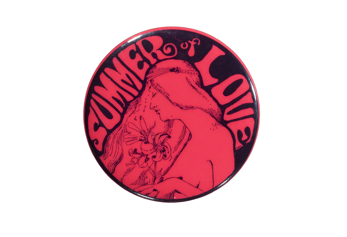 "Summer of Love" Button, circa 1967 Bright pink button with image of long-haired woman holding flowers and text "Summer of Love"