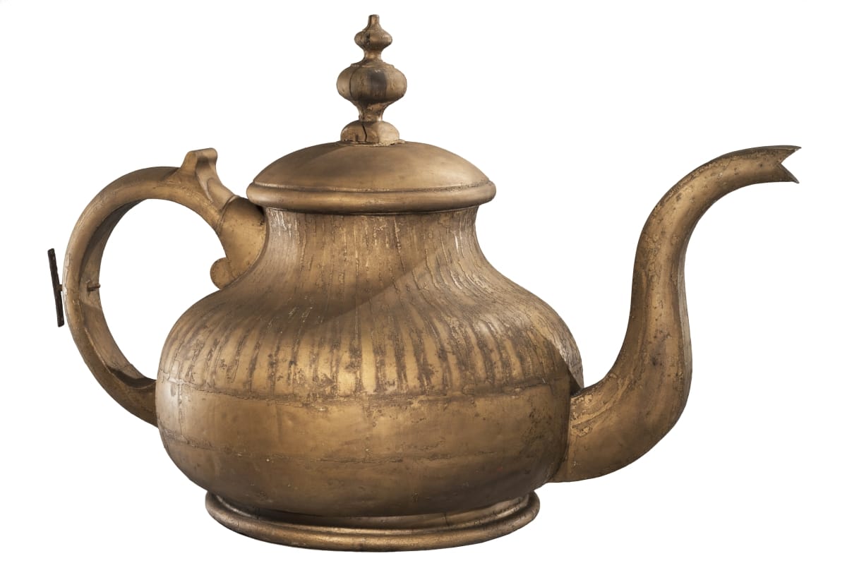 Intricate brass-colored teapot