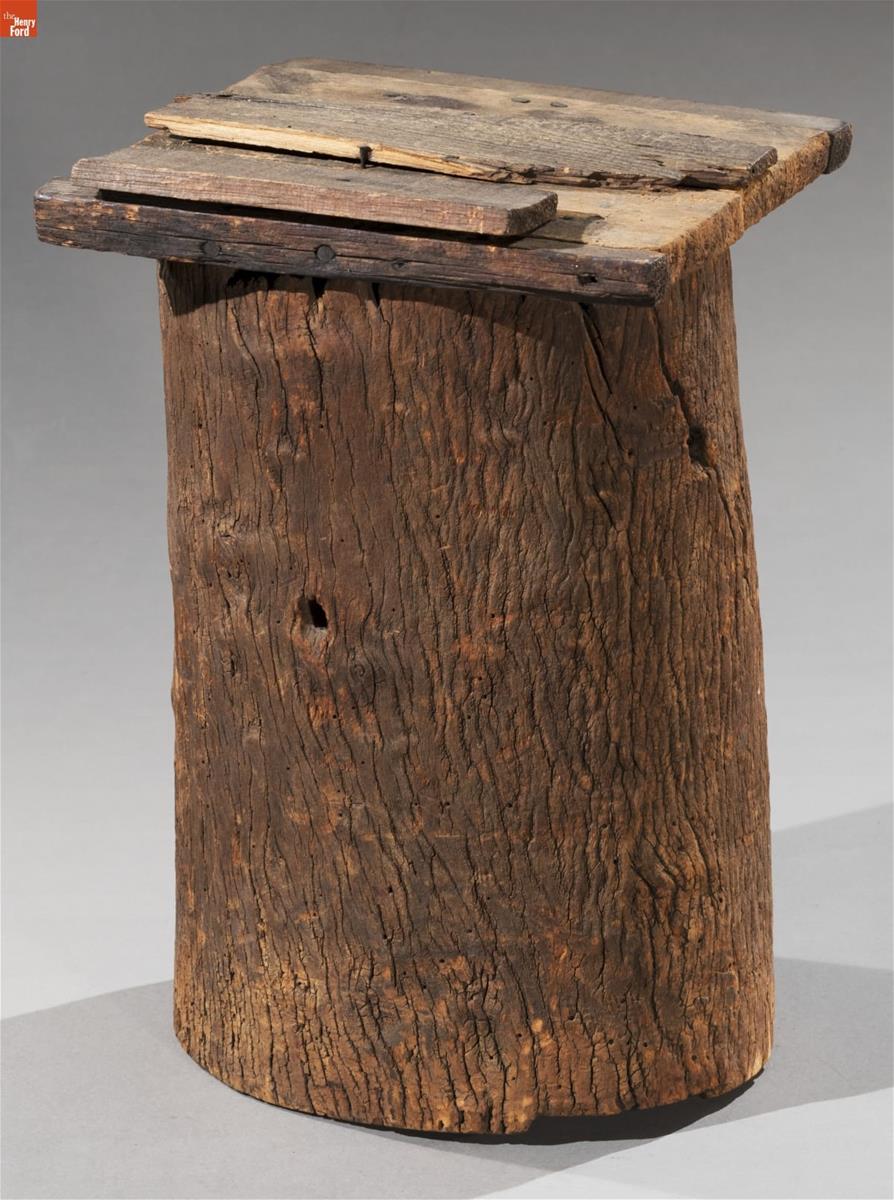 Wooden stump with rough wooden lid on top