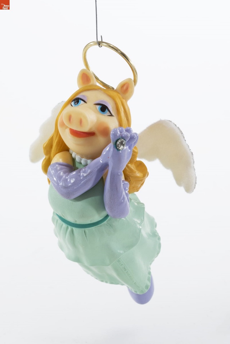 Hallmark "The Divine Miss Piggy" Christmas Ornament, 1981 Christmas ornament of pig in blue gown with purple shoulder-length gloves, blonde hair, and pink angel wings