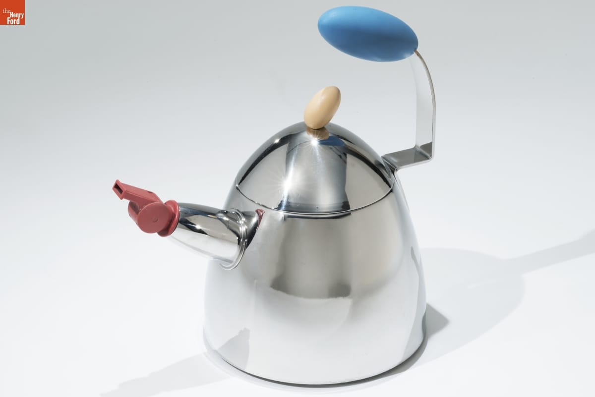 Coach's Whistle Teakettle, Designed by Michael Graves, 1999 Dome-shaped silver teakettle with blue handle on one side and spout on other side topped with a red whistle