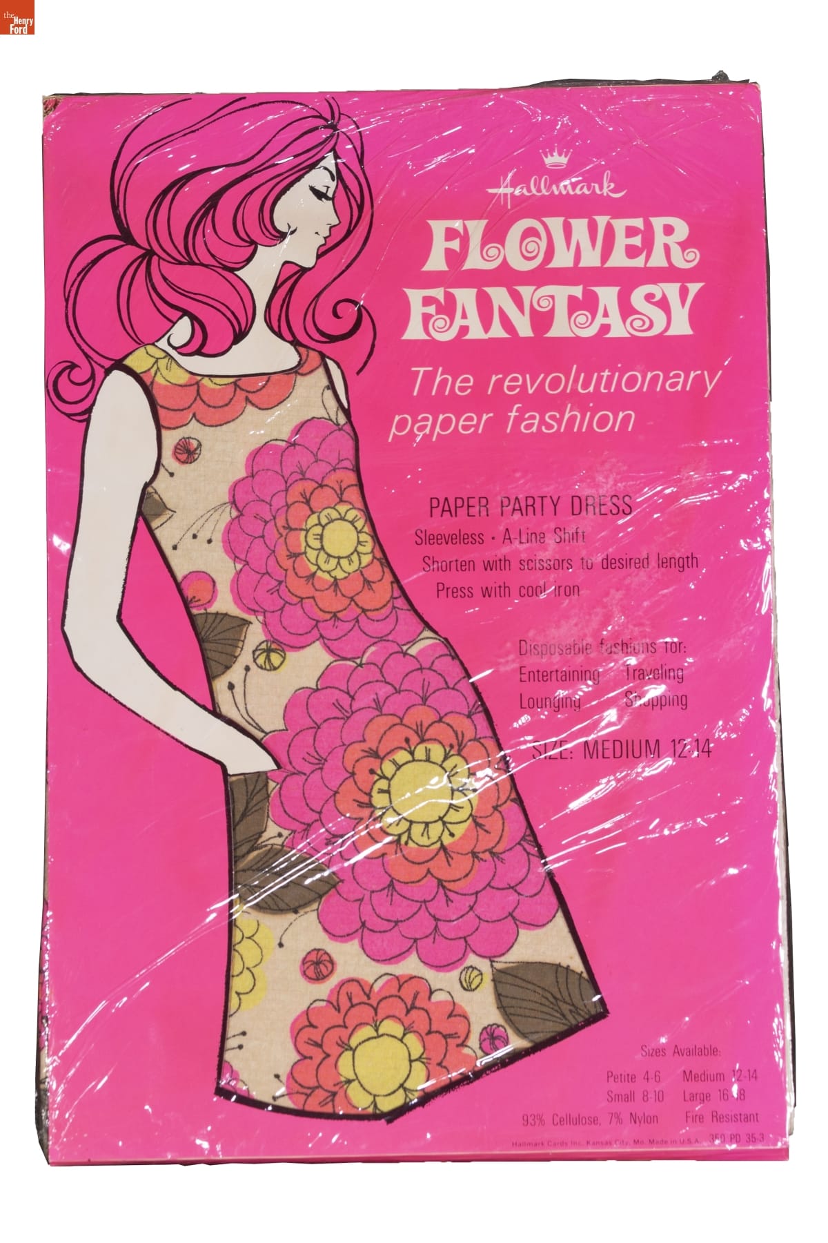Hot pink package with drawing of woman with short dark hair, wearing dress with pattern of holly leaves and berries; also contains text
