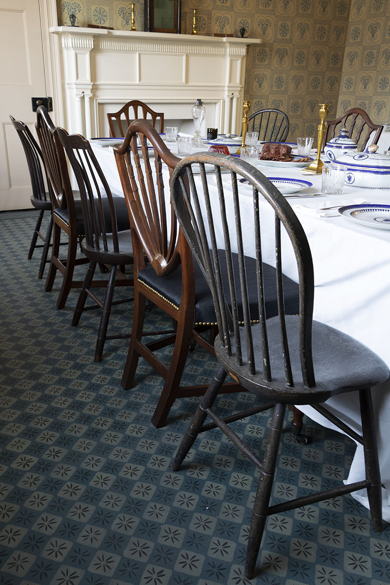 Noah Webster Home / chairs Mismatched chairs along side of table; fireplace in background