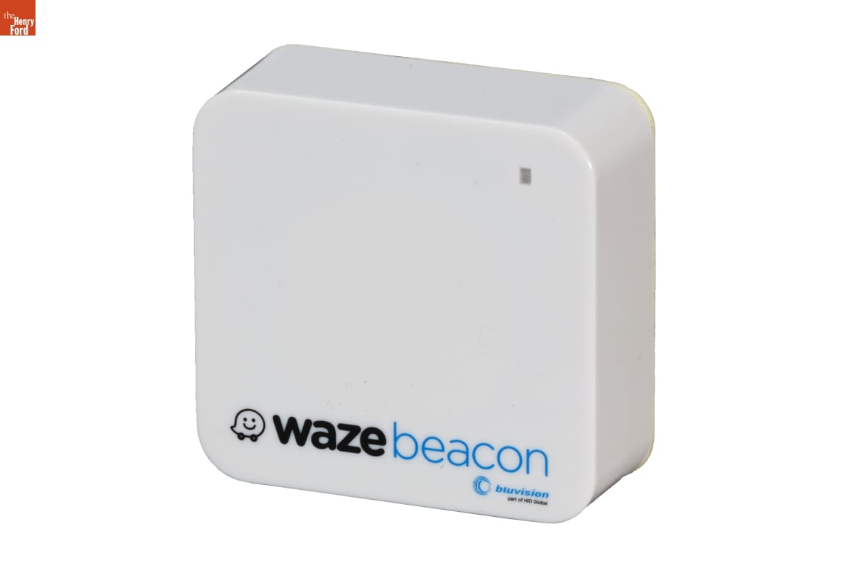 Square-shaped narrow white plastic box with text "wazebeacon"