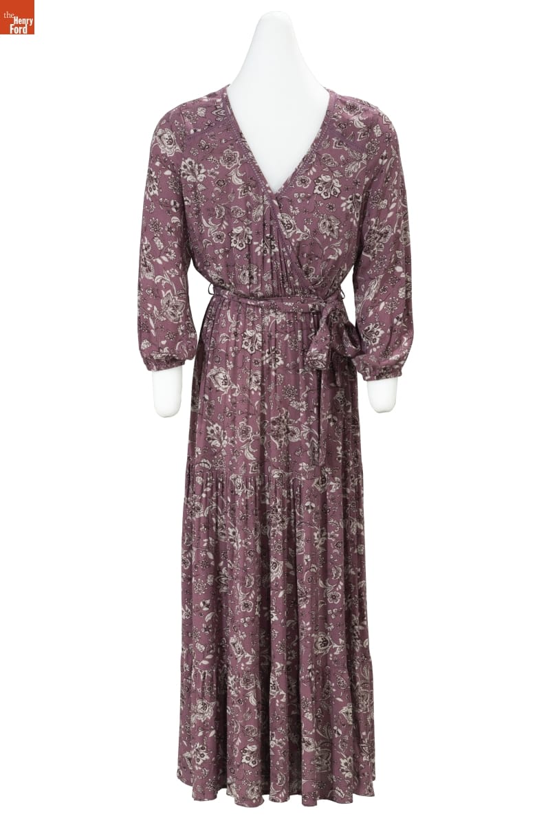 Floor-length, long-sleeved, v-necked purple dress with lavender and black paisley pattern and tie at waist