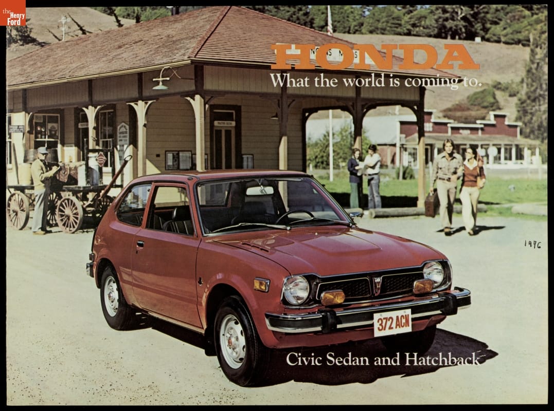 Page with text and photo of small red/brown car parked in front of a wooden building with people and a carriage nearby