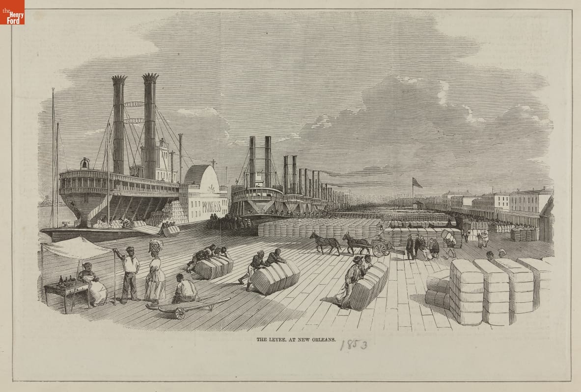 Print depicting large wooden dock filled with bales of cotton, with many steamships docked