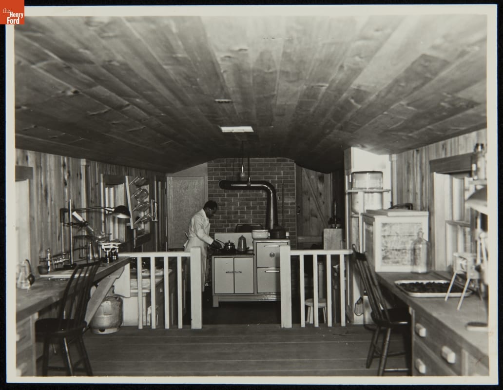 Making Soybean Bread in the Soybean Laboratory in Greenfield Village, Dearborn, Michigan, circa 1935 Man in an apron works at a stove at the far end of a room filled with workspaces and equipment