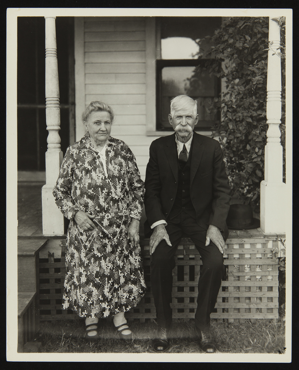 Mr. and Mrs. Watkins Woman and man sit on the edge of a porch