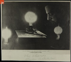 Portrait of Charles Batchelor, Man bows his head, eyes closed, among three illuminated light bulbs