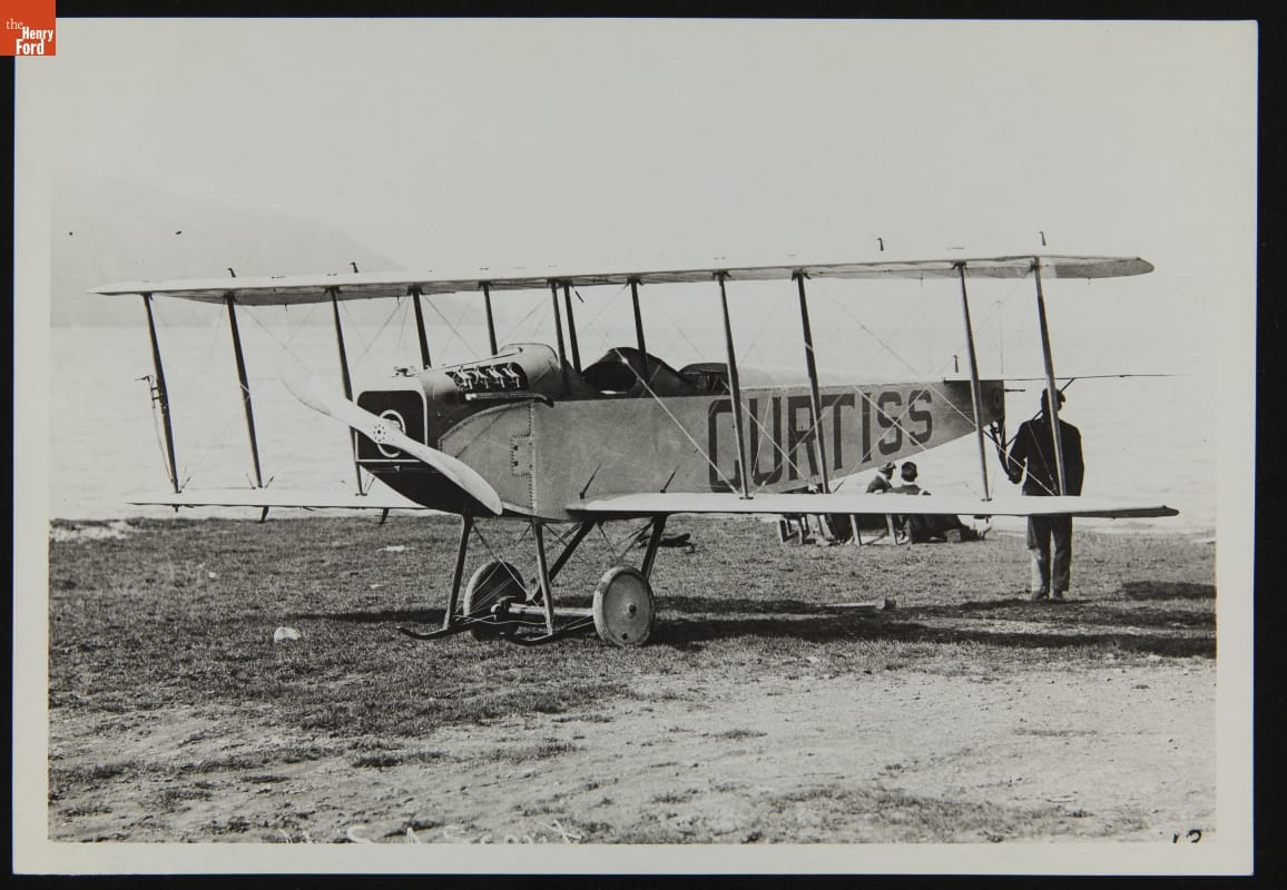 Man standing at back of airplane with large text 
