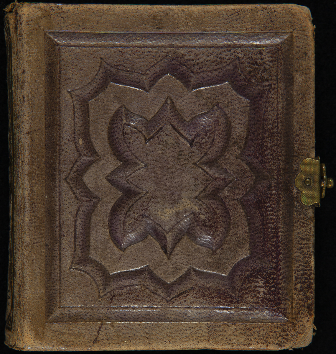 Embossed brown leather album cover with brass hasp at right