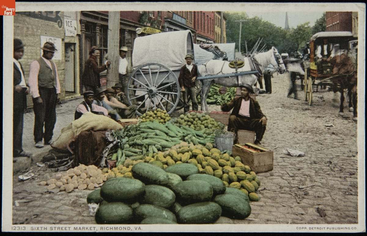 Sixth Street Market, Richmond, Va., 1908-1909 Men sitting and standing by large piles of vegetables at the edge of a street with horses and wagons behind them