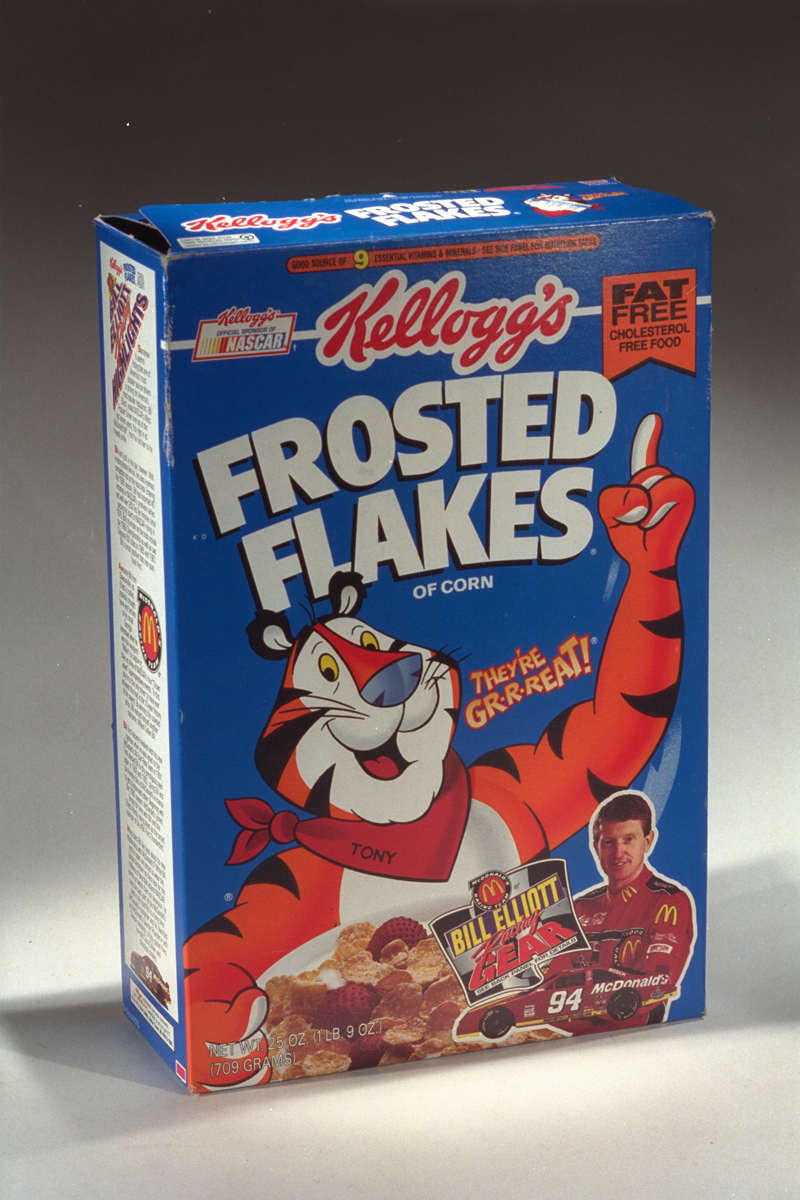 Blue Kellogg's Frosted Flakes Breakfast Cereal box, 1994-1996, with orange-and-white “Tony the Tiger” and picture of racer Bill Elliott
