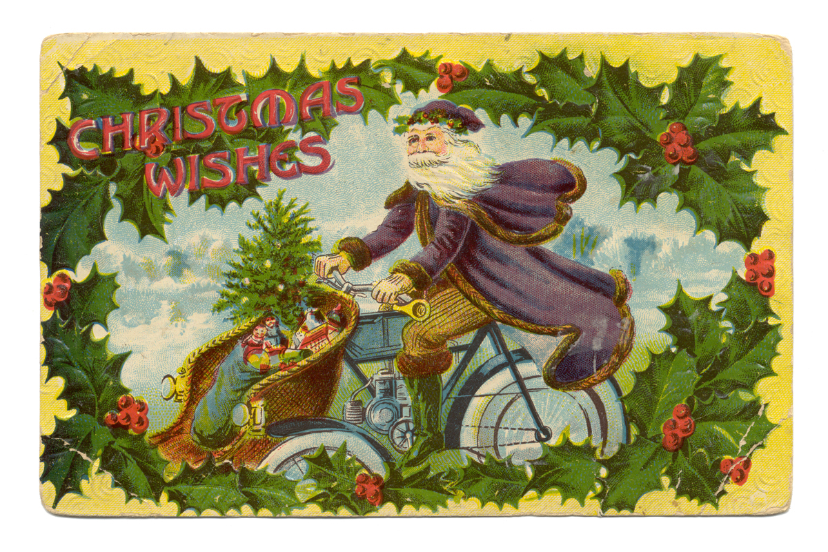 Christmas Greeting Postcard, "Christmas Wishes," 1910-1920 Postcard of St. Nick in purple cape on motorcycle with toys in front basket; contains text and border of holly leaves and berries