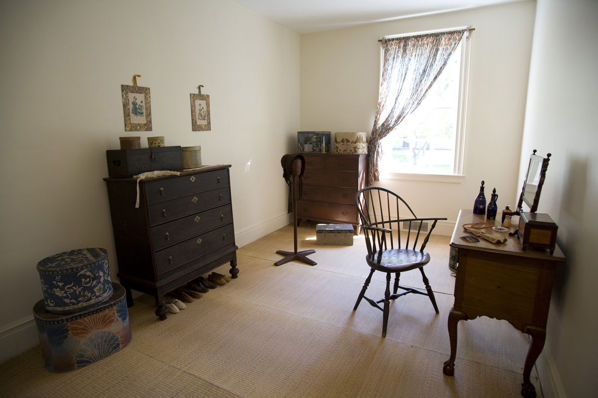 Noah Webster Home in Greenfield Village, September 2007 Narrow room with one window, chair and desk, two dressers, and other furnishings