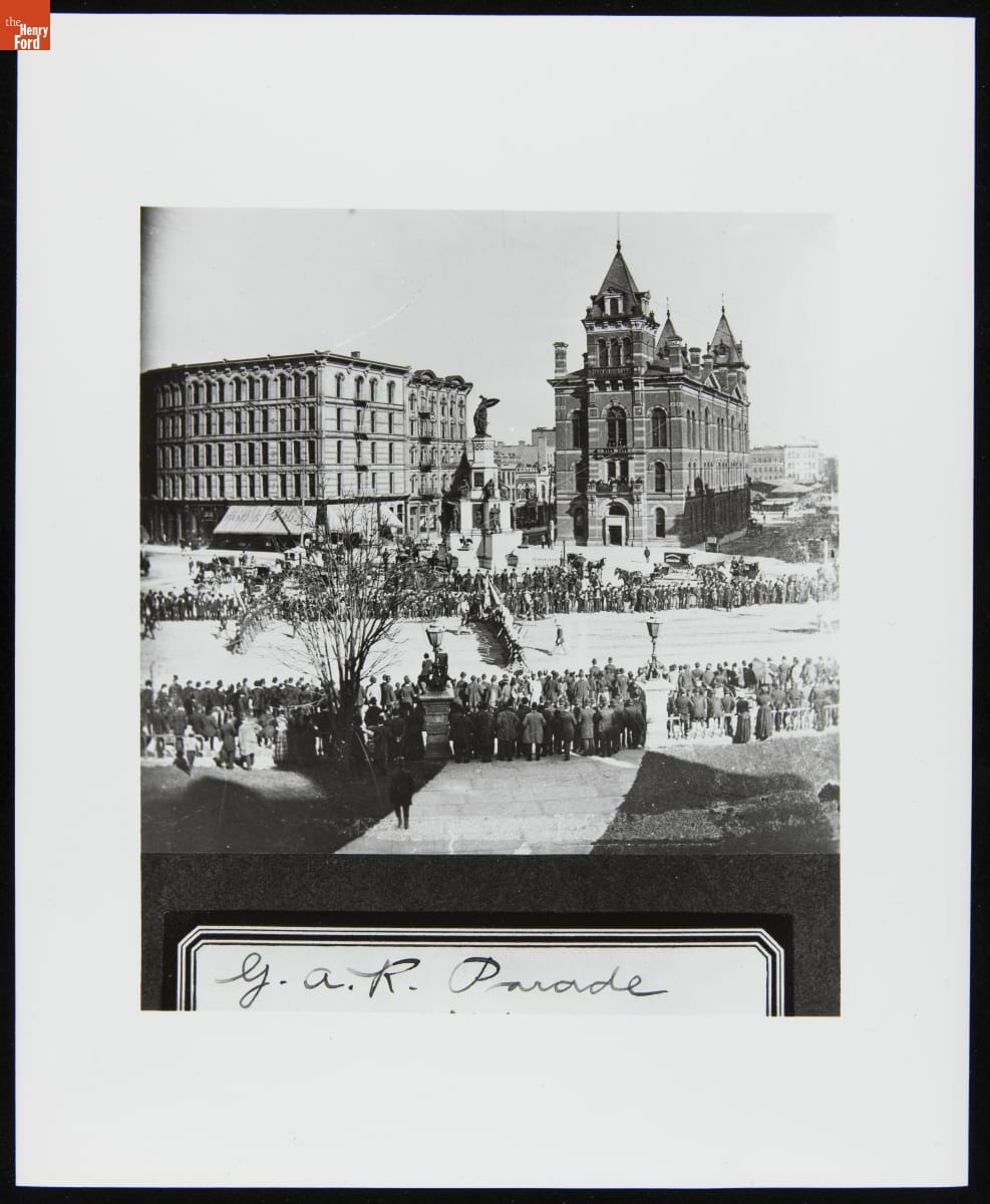 Grand Army of the Republic Parade at Campus Martius, Detroit, Michigan, 1881 Open city square containing large monument and many people gathered around