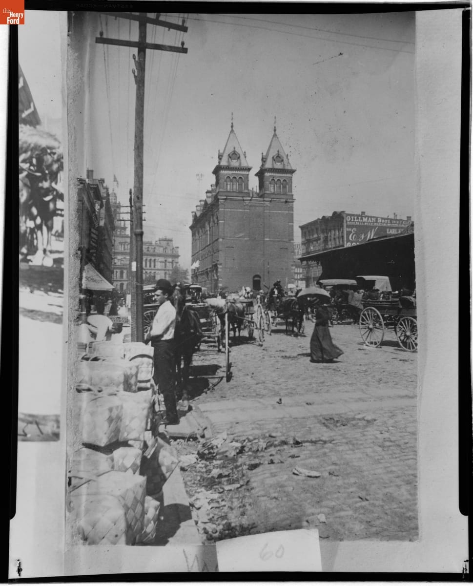 Customer at Central Market Vegetable Building, Detroit, Michigan, 1885-1893 Street scene with people, horses and carriages, and buildings