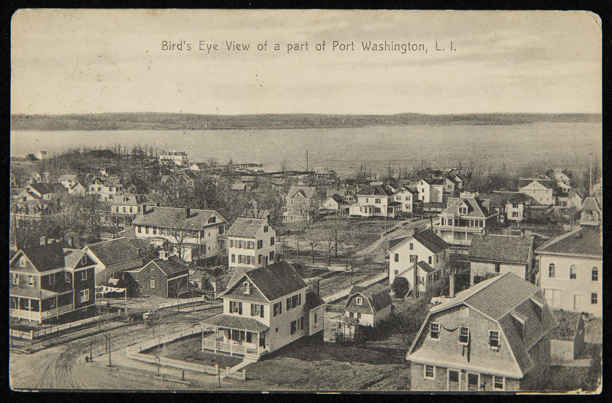Town with two-story wooden houses by a body of water; also contains text