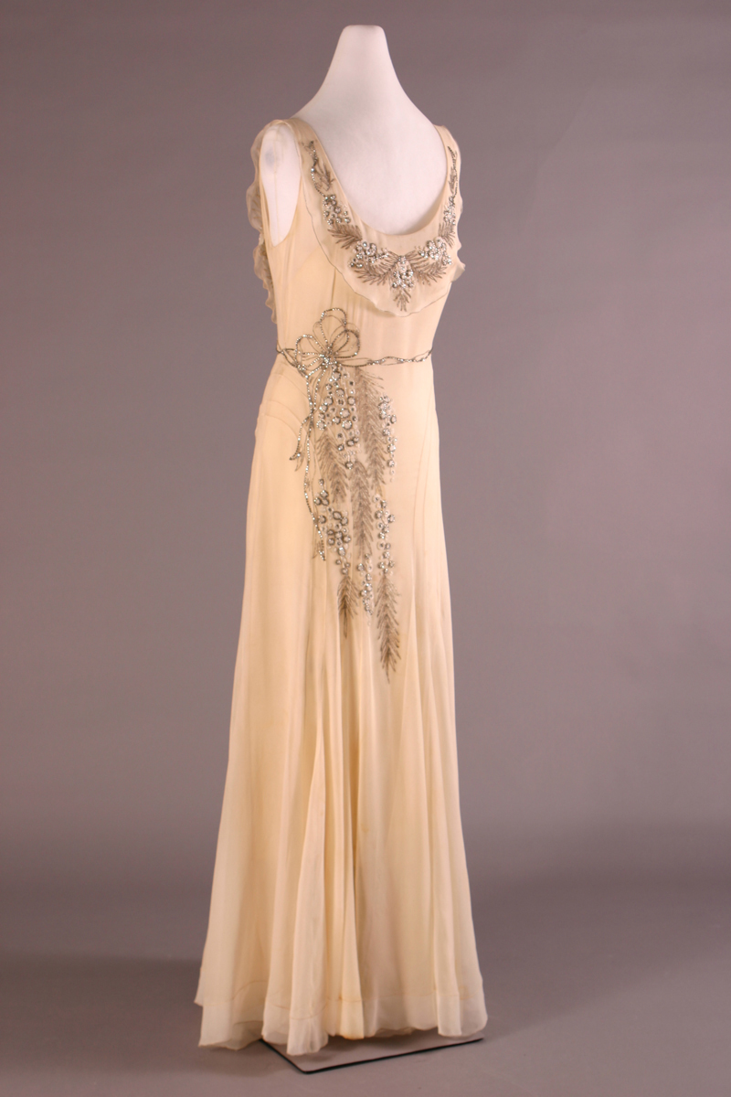 Evening Dress, Worn by Elizabeth Parke Firestone, 1931 Beige or pale peach sleeveless dress with beaded detailing
