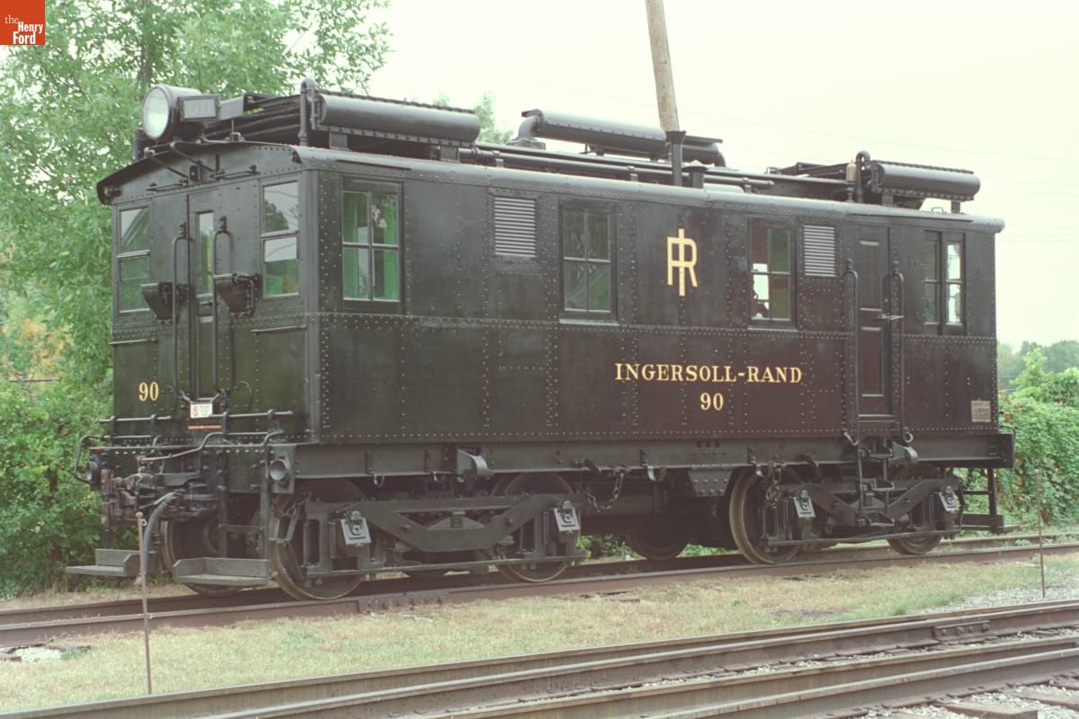 Black rail car on railroad tracks