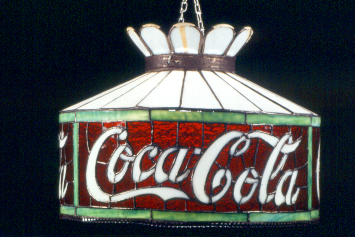 Coca-Cola Chandelier, circa 1900 Stained glass lamp in shades of white, green, and red, with white cursive text "Coca-Cola"