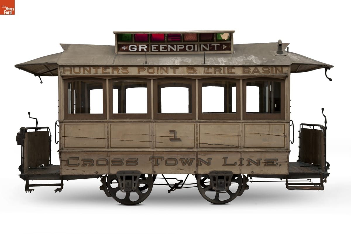 Jones Horse-Drawn Streetcar, circa 1875 Wooden streetcar on metal wheels, with colored glass in top turret and text on side