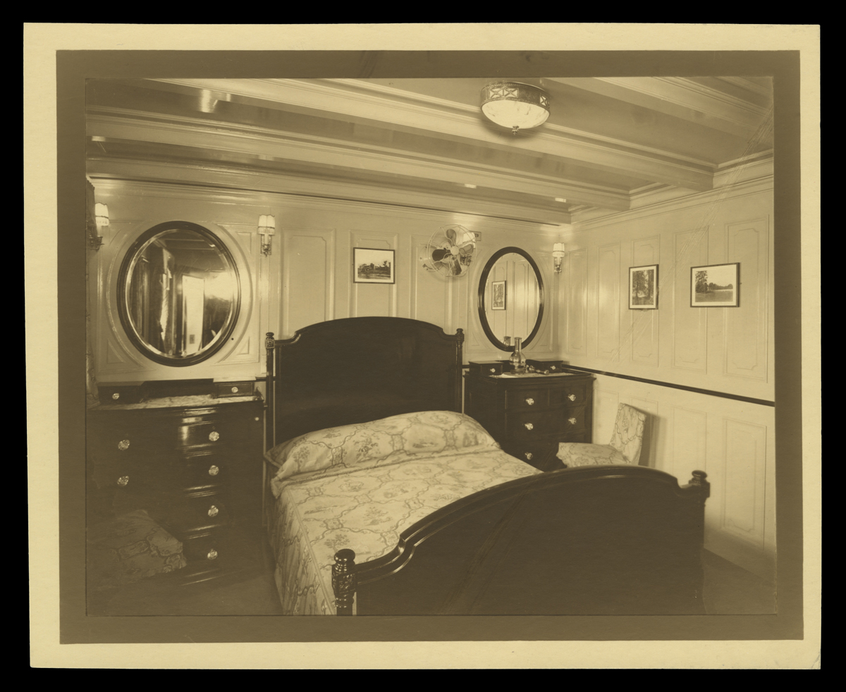 Bedroom on "Sialia," Henry Ford's Yacht, circa 1925 Small room containing double bed with a dresser on either side and a round mirror above each dresser