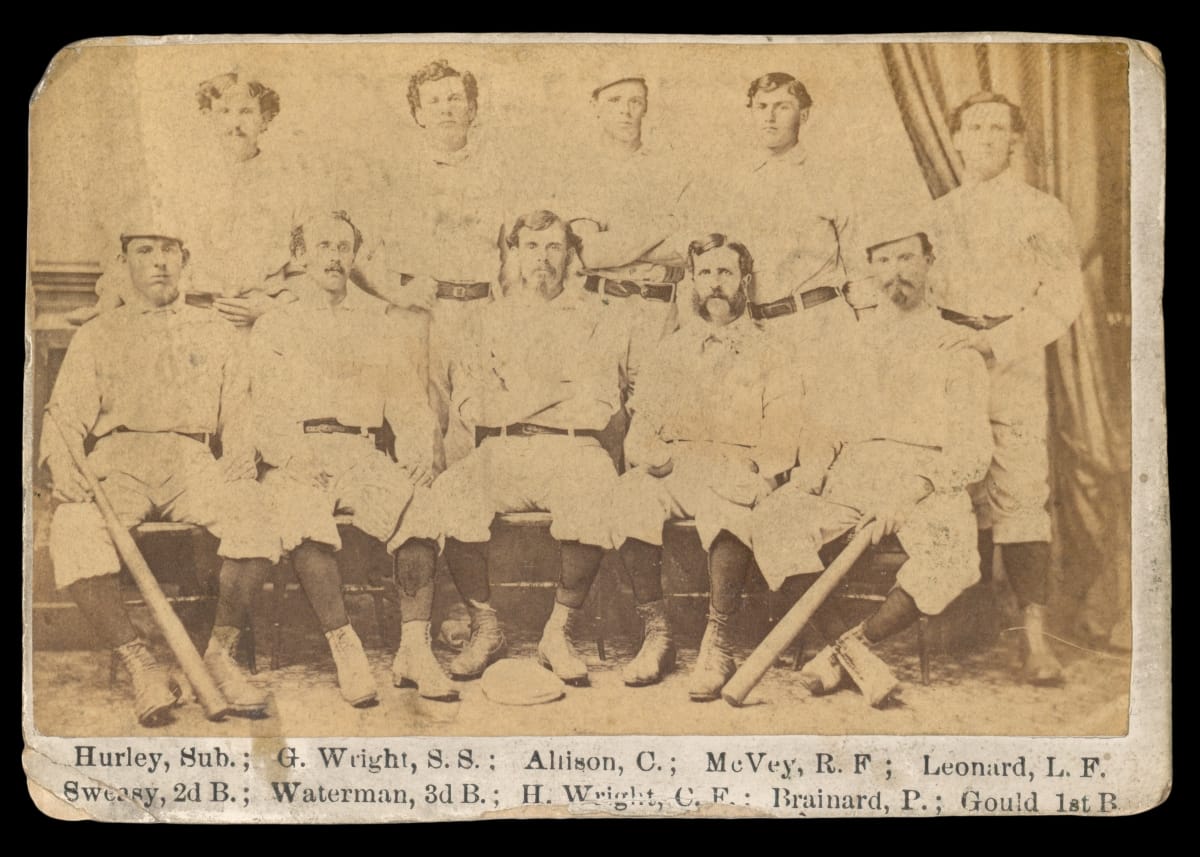 1869 Peck & Snyder Cincinnati Red Stockings Card Black-and-white photo of 10 men in baseball uniforms, some holding bats, with text underneath