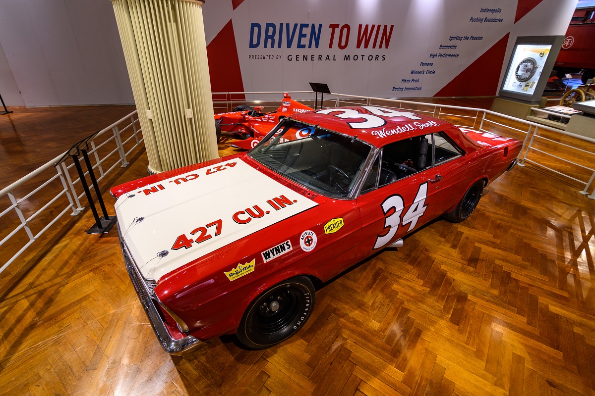 Red car with white hood; text in multiple areas including "34" on door and roof, "Wendell Scott" on roof