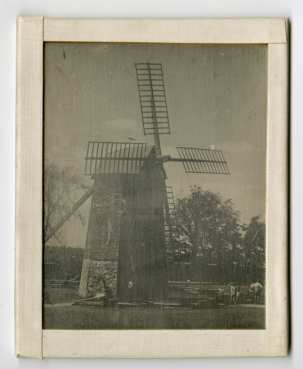 Black-and-white image of windmill in frame