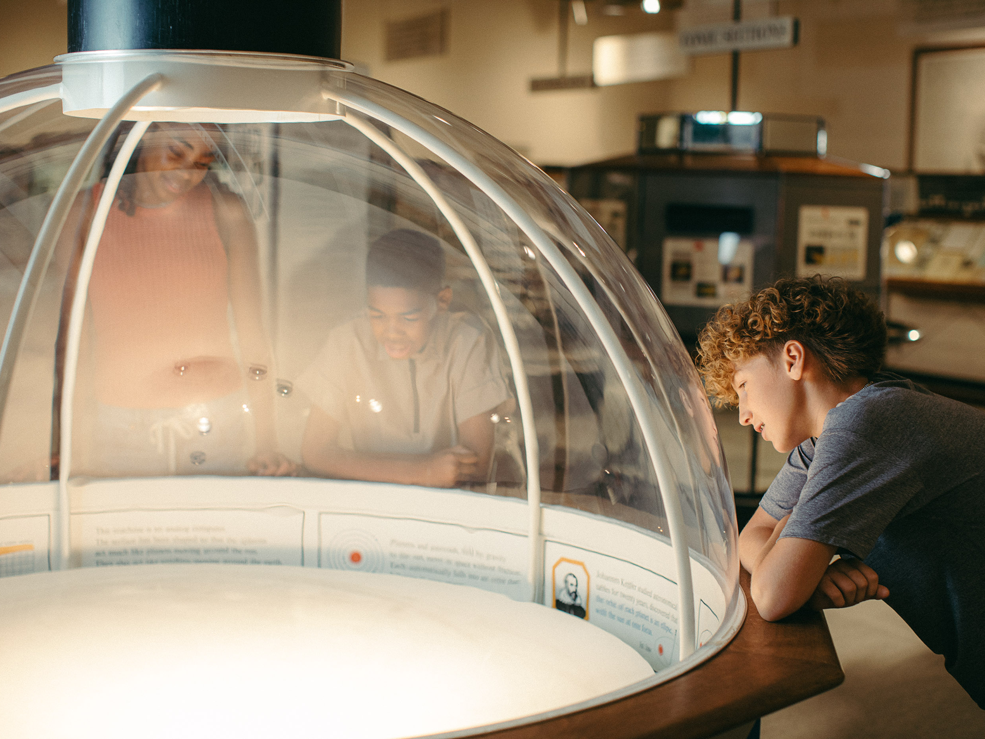 Young guests gather around a display in the Mathematica exhibition